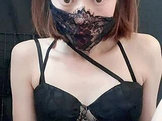 Redheaded webcam performer in black uniform pleasuring herself on camera