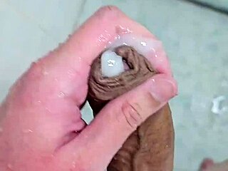 Beautiful young man enjoys a sensual bath with cum