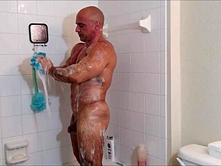 A solo man enjoys a sensual shower with soap and oil