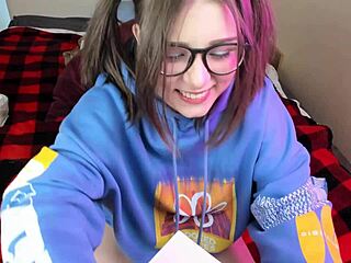 Nerdy glasses girl masturbates and swallows a dildo on webcam